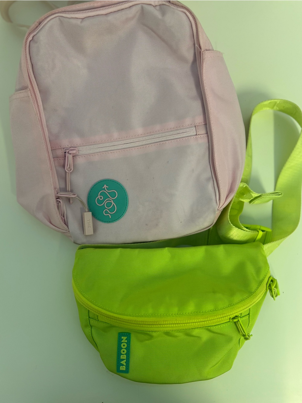 Baboon to the Moon Neon Green Waist Bag and Pink Mini Backpack Bag Duo